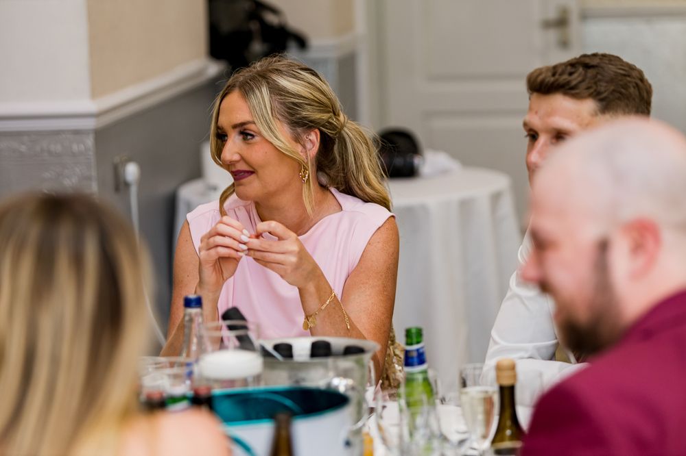Elegant wedding reception dinner with guests enjoying the celebration at decorated tables.