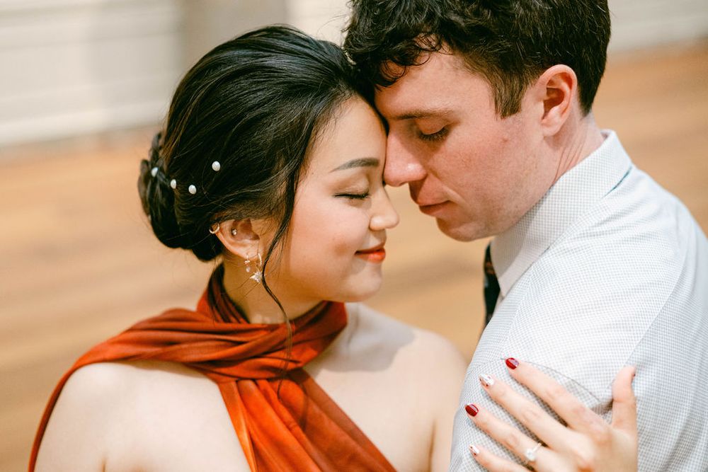 A romantic couple in white and orange outfits share tender moments in a series of intimate photographs.