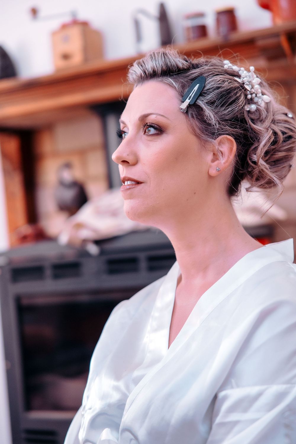 A sequence of profile shots showing a person in a white dress with an elegant updo hairstyle and makeup.