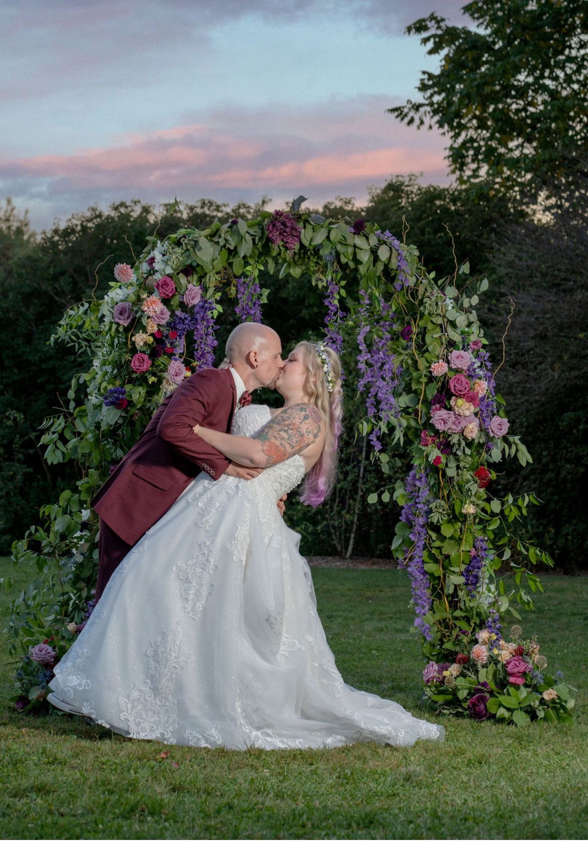 Photo of a groom kissing and dipping his bride at The Arboretum in Guelph ON