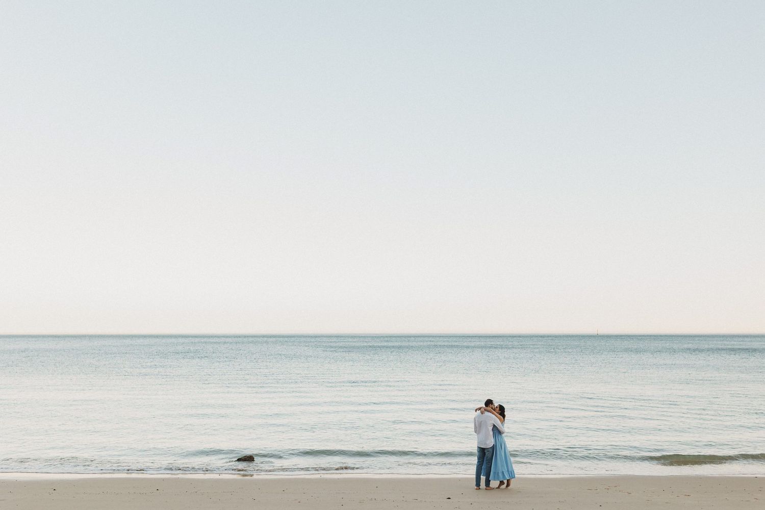 Romantic pre-wedding photos in Arrábida with couple hugging above the beach