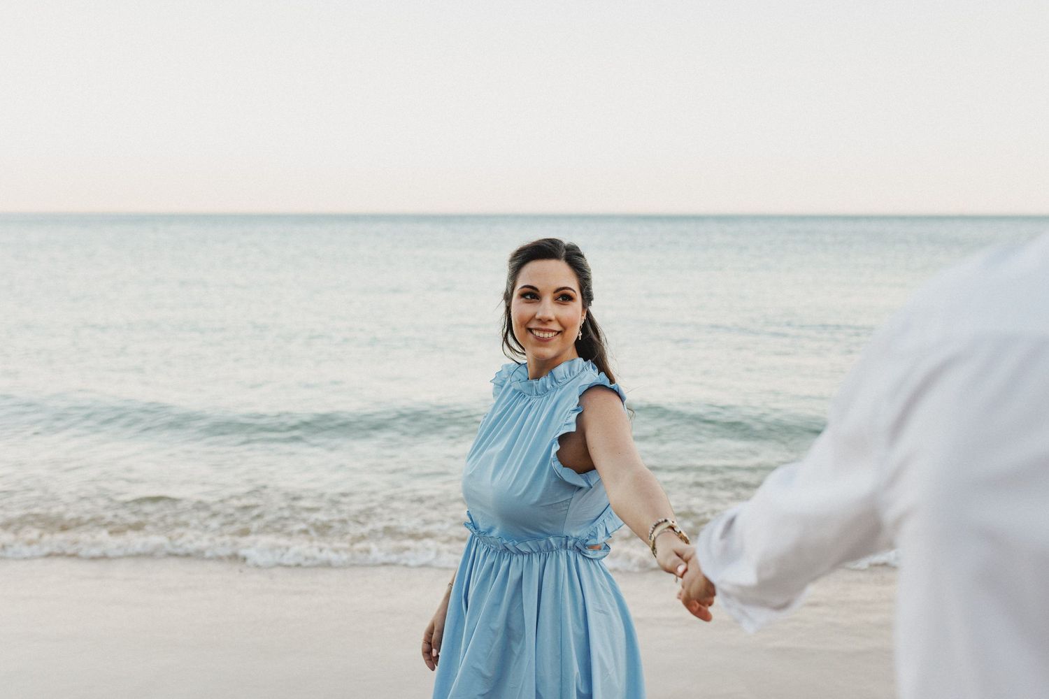 Pre-wedding photos near Lisbon with couple embracing on the beach