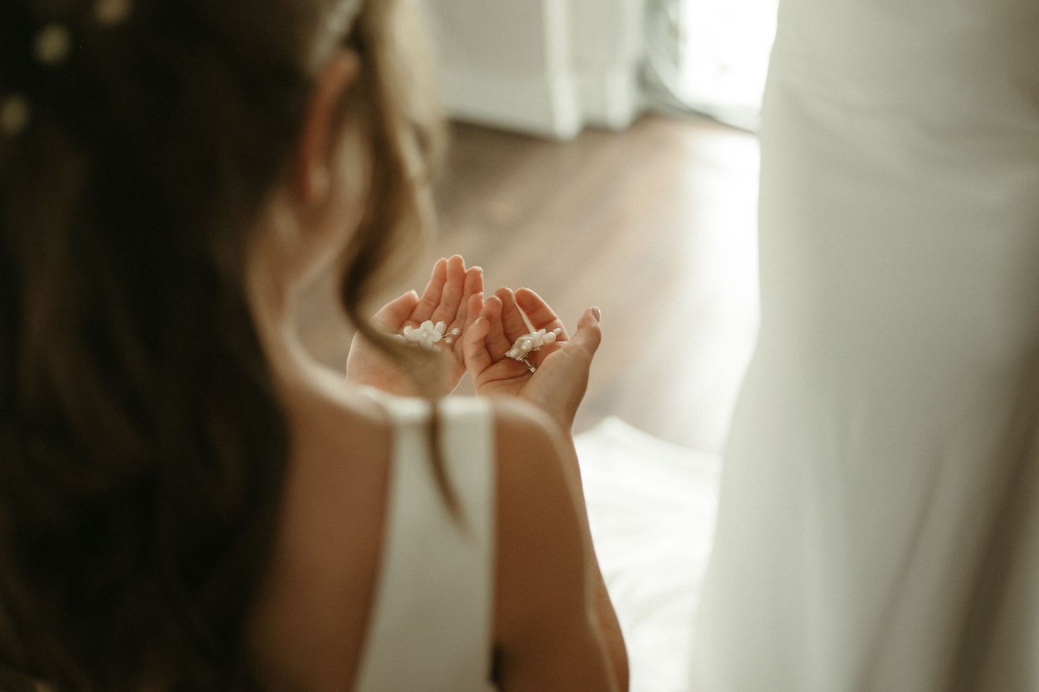Close-up of flower girl holding flower petals in her hands at wedding.