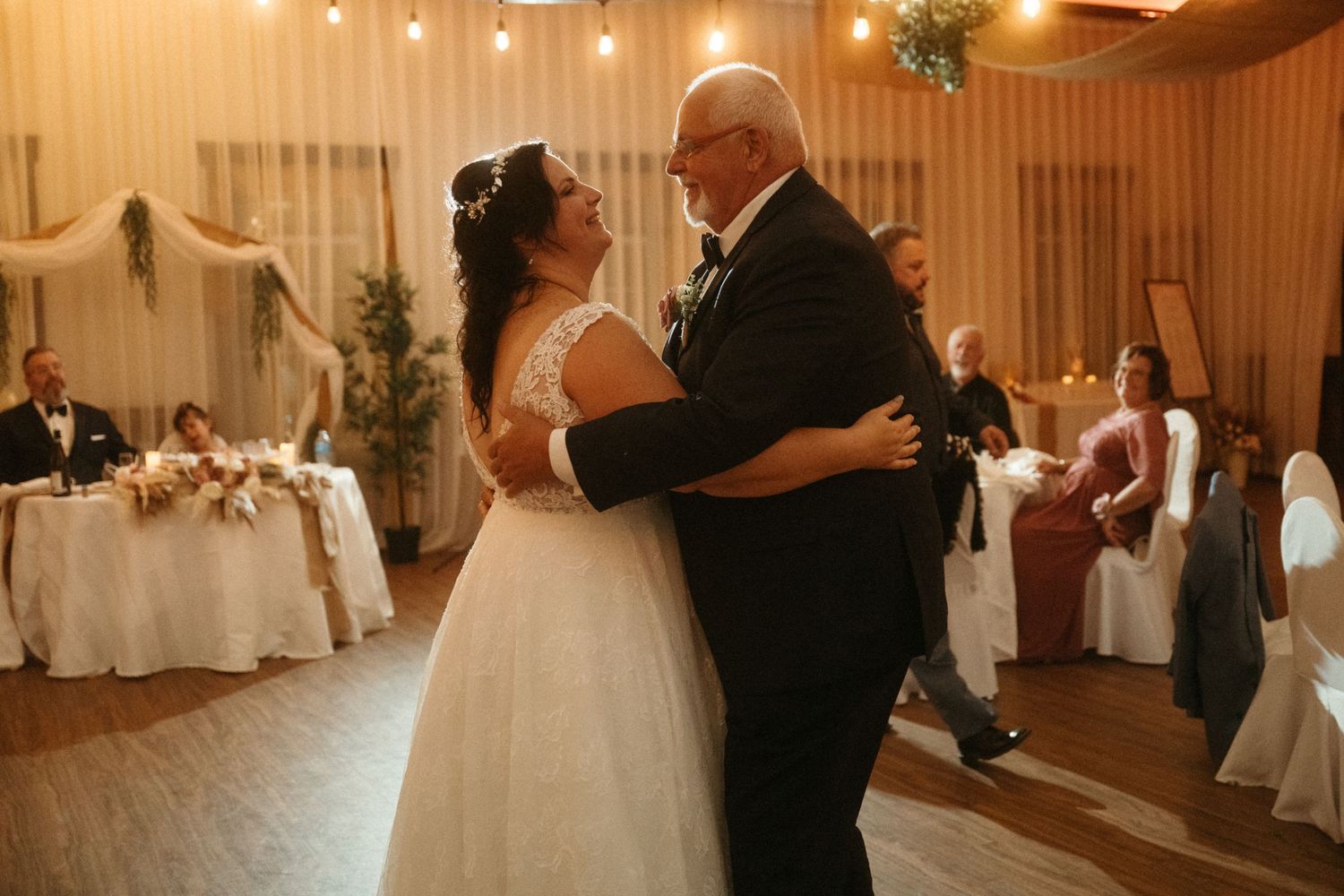 A bride and groom share their first dance together at their elegant wedding reception.