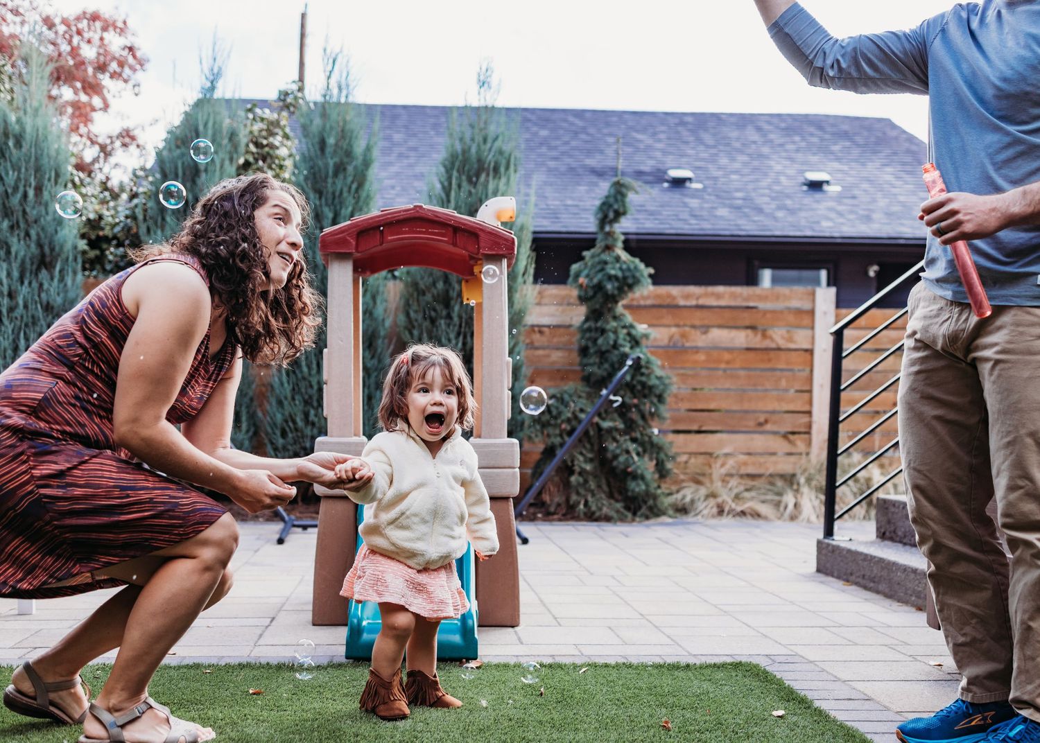 A sequence of candid outdoor photos showing people playing lawn games and socializing in a backyard setting.