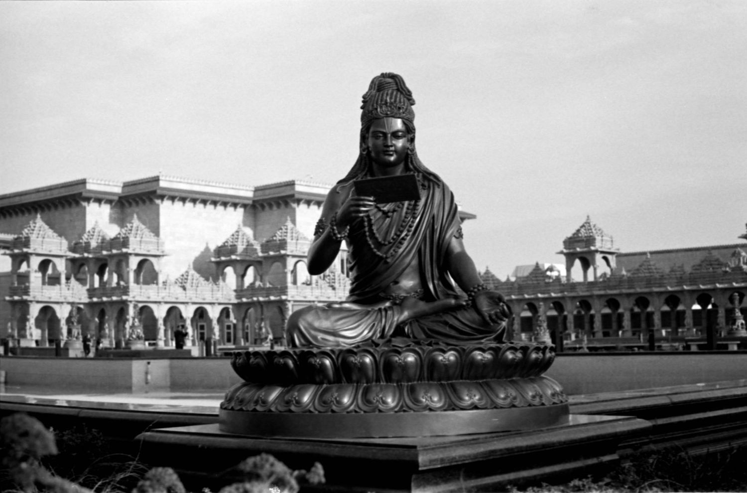 A panoramic view of temple architecture featuring Buddha statues and traditional Asian religious structures.