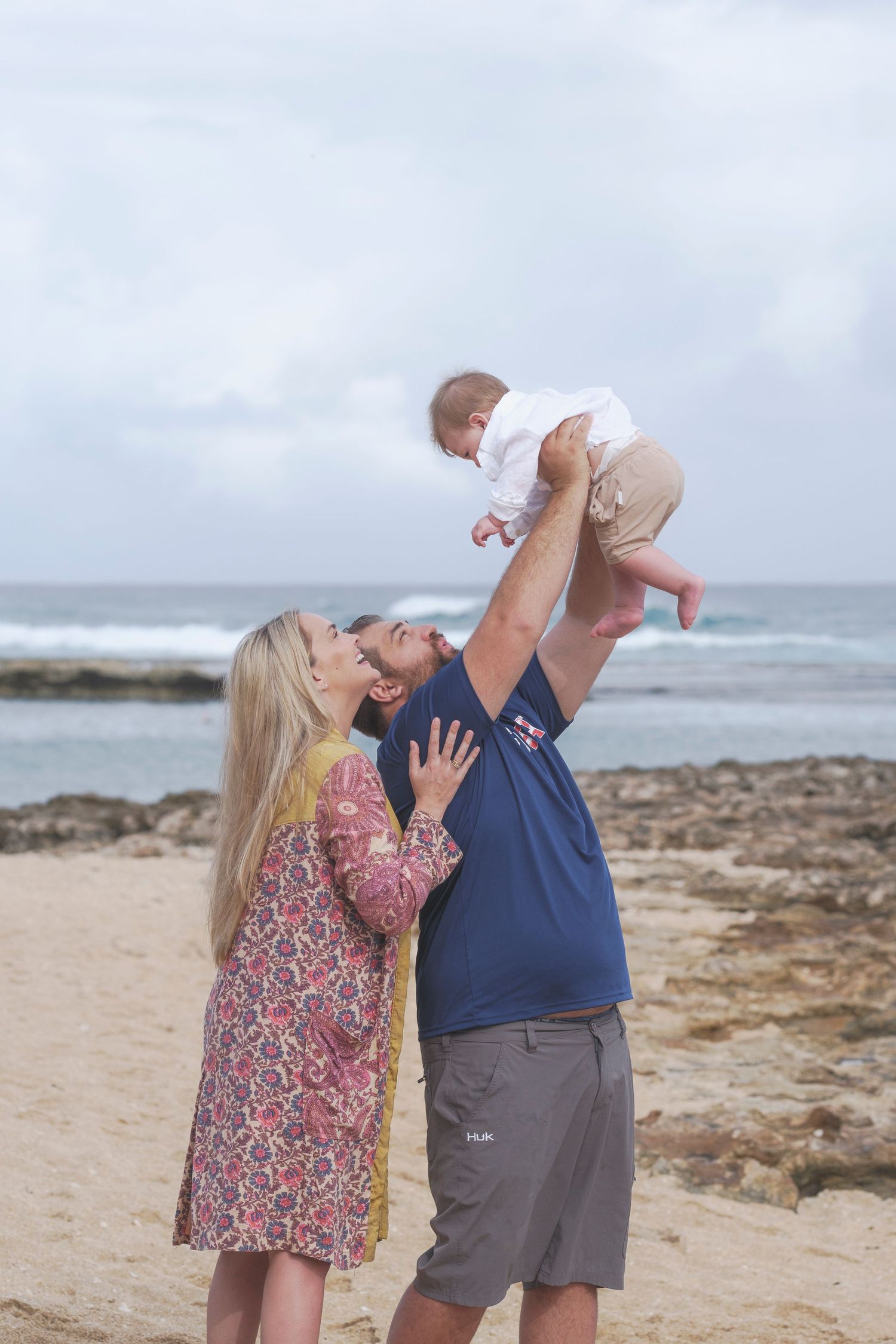 Family playing during a family beach photoshoot on the North Shore Oahu, Hawaii