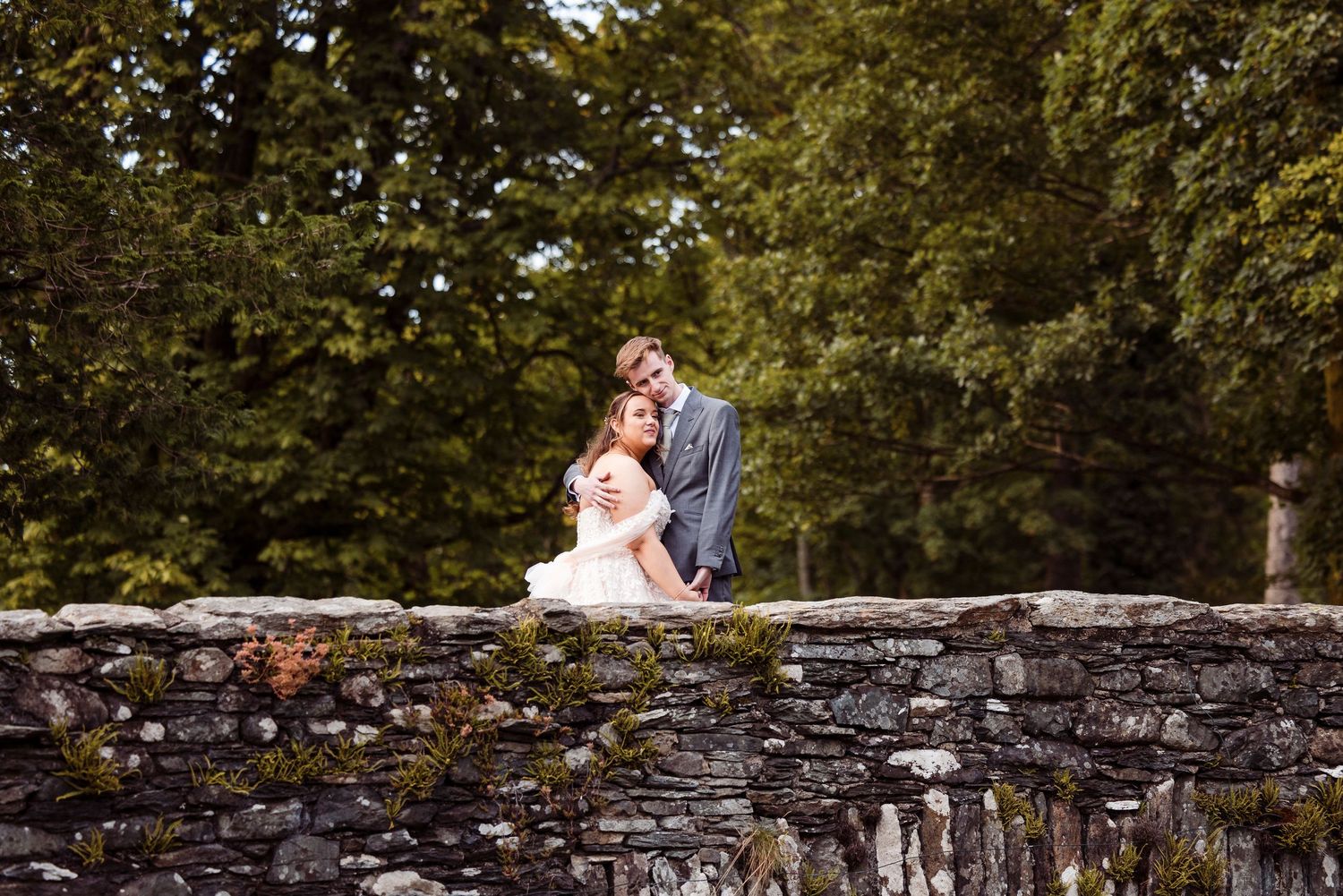 Bride and groom by on the stone bridge at Lodore Falls Hotel