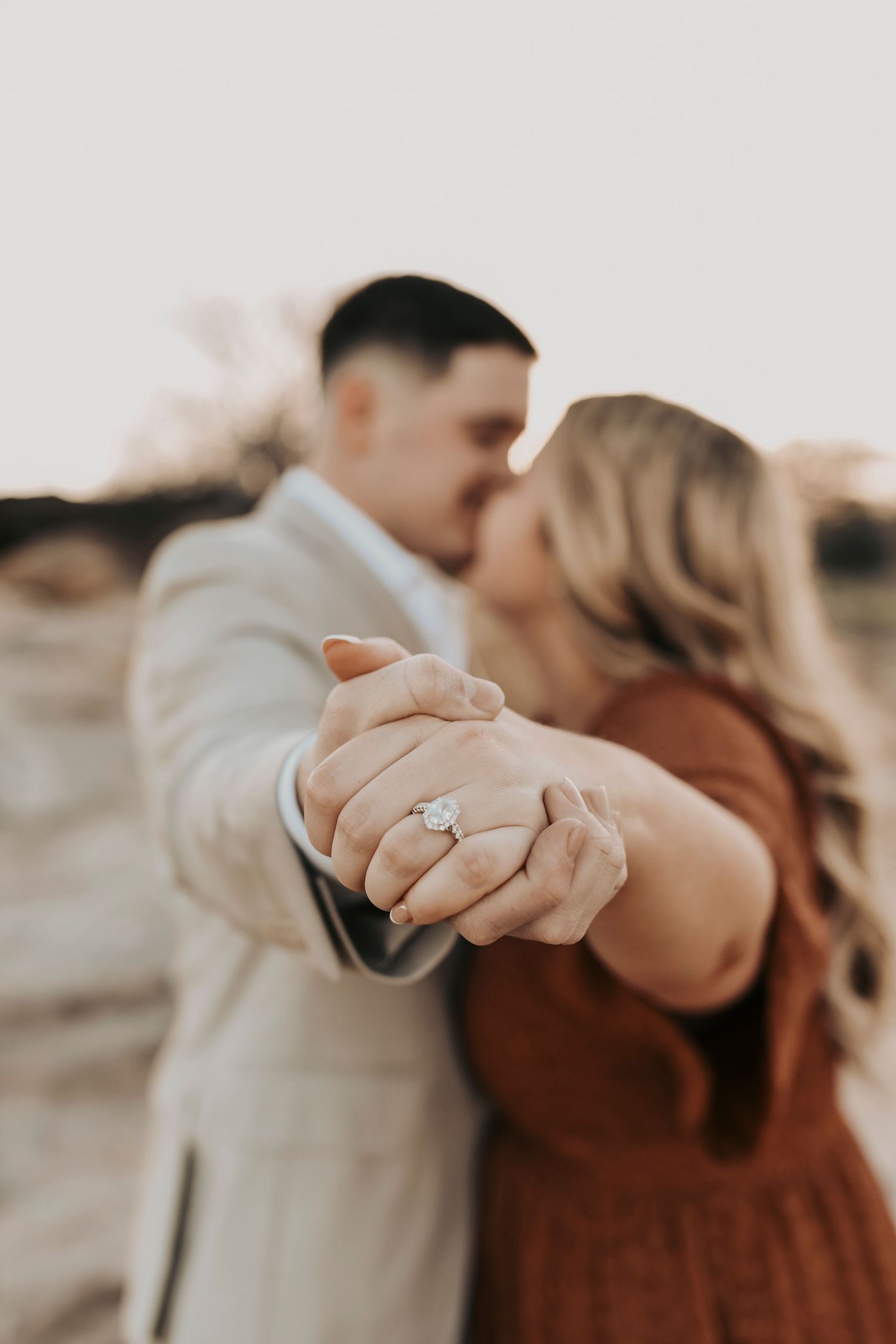 Gavin wearing a neutral linen suit during Flower Mound engagement photos.