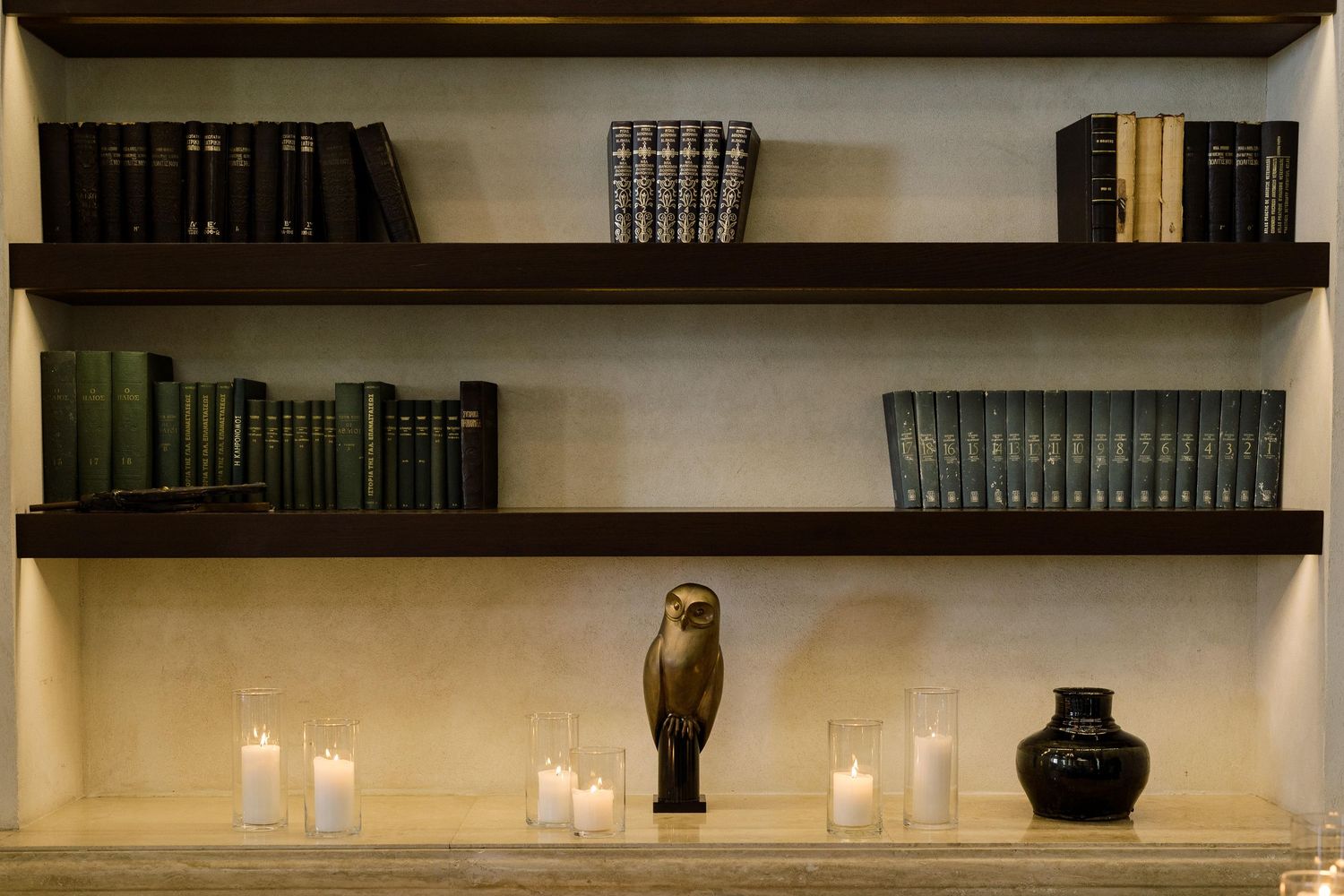A rustic wooden shelf display with decorative vases, candles, and ornamental items arranged in a modern farmhouse style.