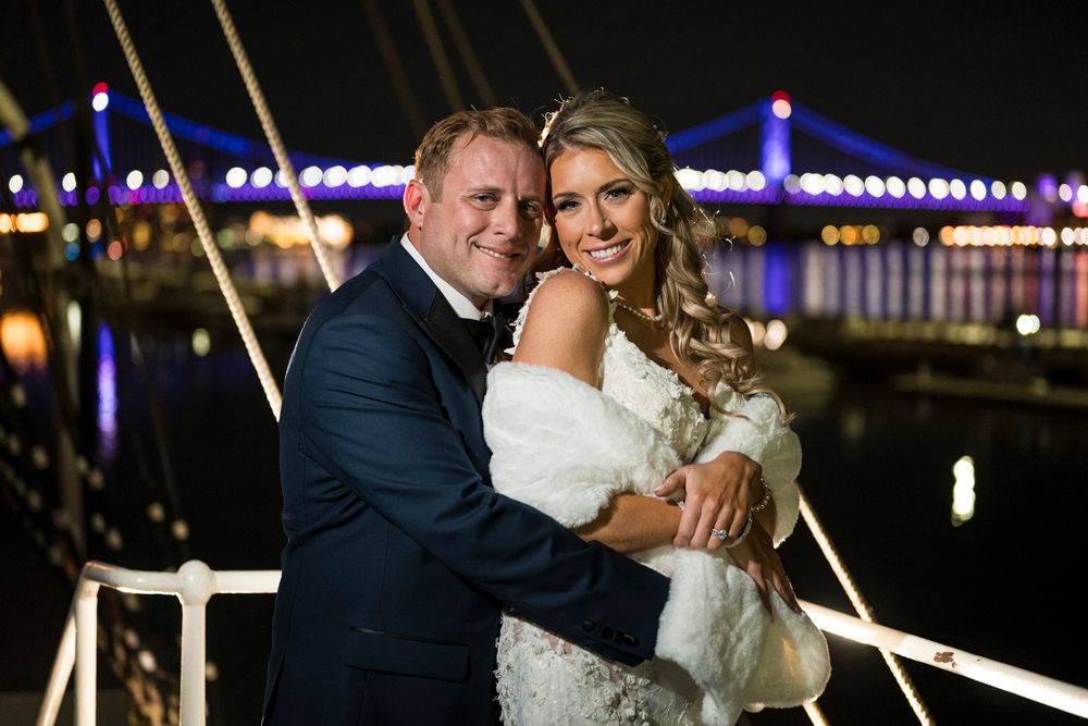 Romantic nighttime wedding portraits with glowing lights and decorative elements in the background.