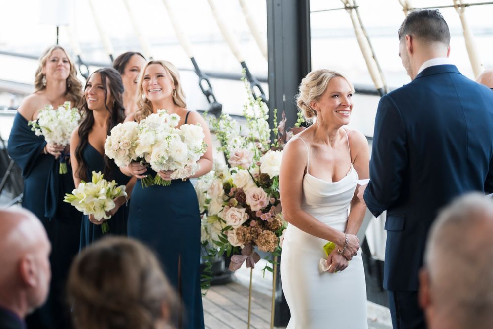 Wedding celebration on an outdoor terrace with floral arrangements and natural lighting.