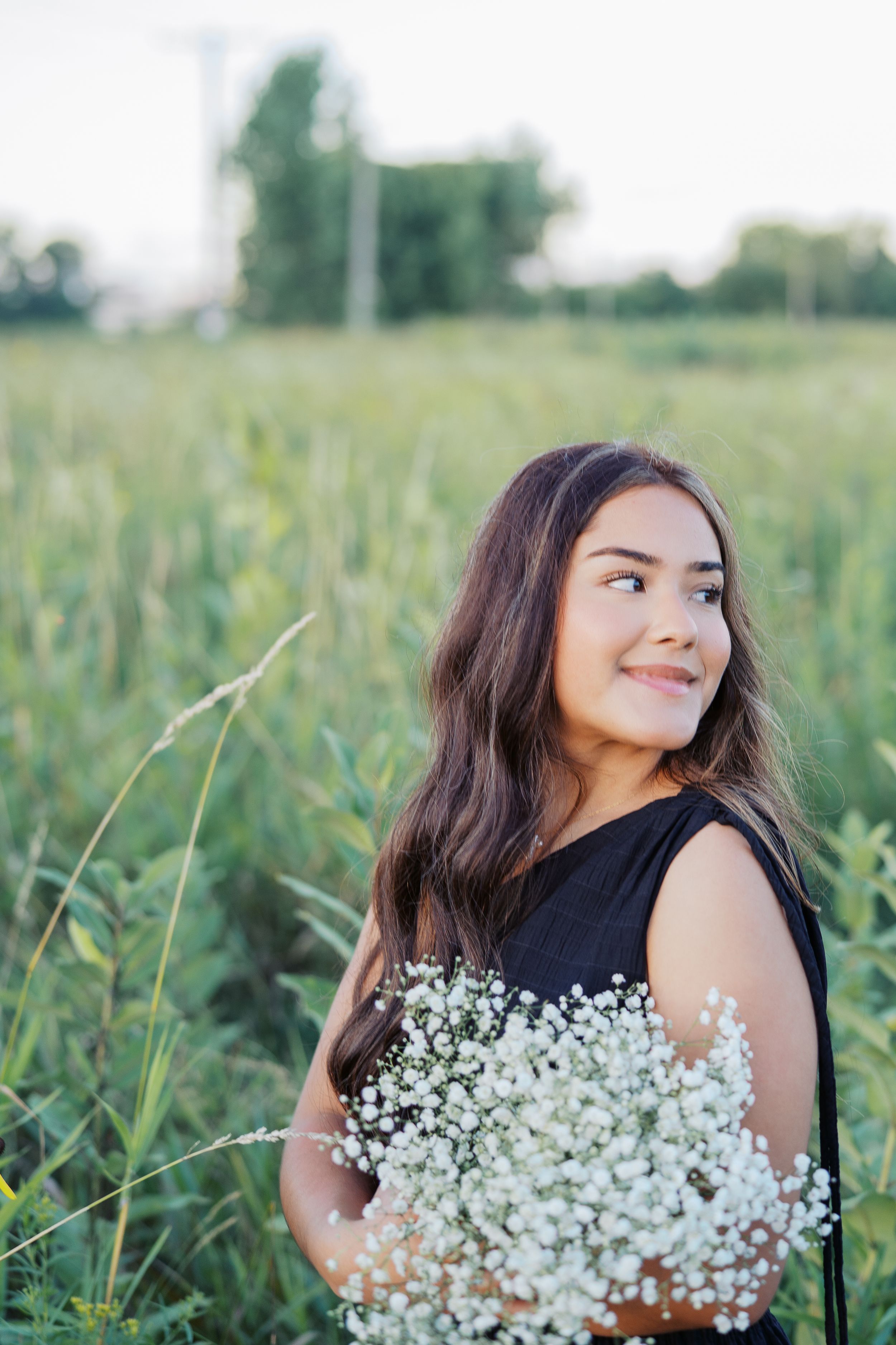 Joyful summer portraits with baby's breath bouquets in a sun-drenched field.