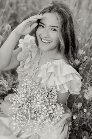 Black and white portraits with baby's breath flowers and ruffled details creating romantic atmosphere.