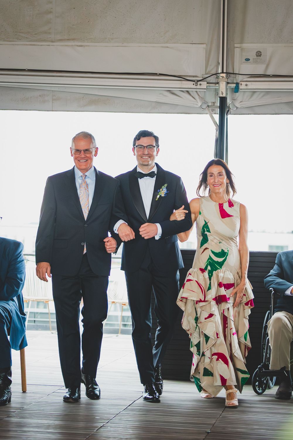 a groom along with this parents walking down the aisle at the line DC