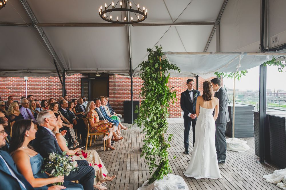 A panoramic collage of wedding guests mingling at an elegant indoor reception venue with washington dc views.