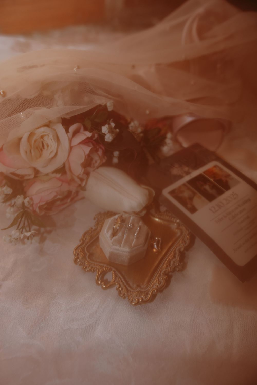 Soft sepia-toned still life composition featuring delicate roses and vintage ornate frames creating a romantic atmosphere.