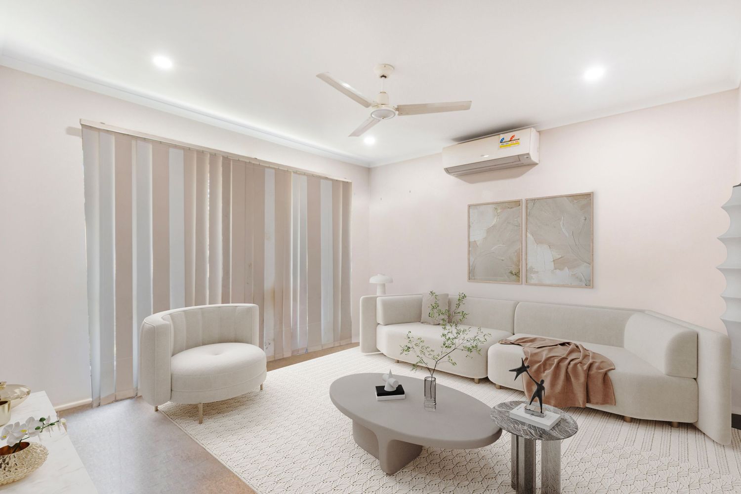 Modern living room with white sofa, round coffee table, ceiling fan, split-system AC, and sheer curtains.