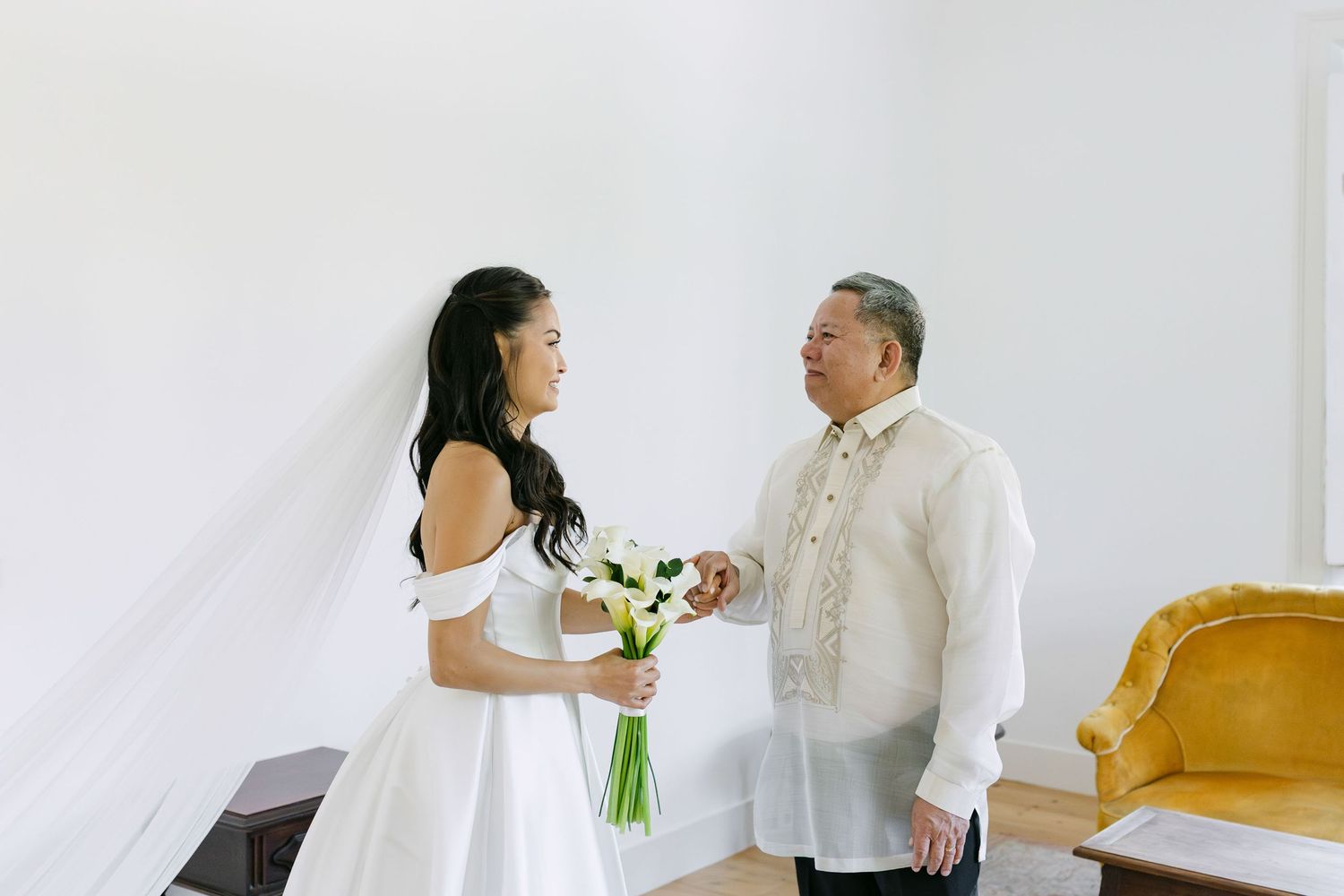 Emotional first look between bride and father figure during wedding preparations in Lisbon Portugal