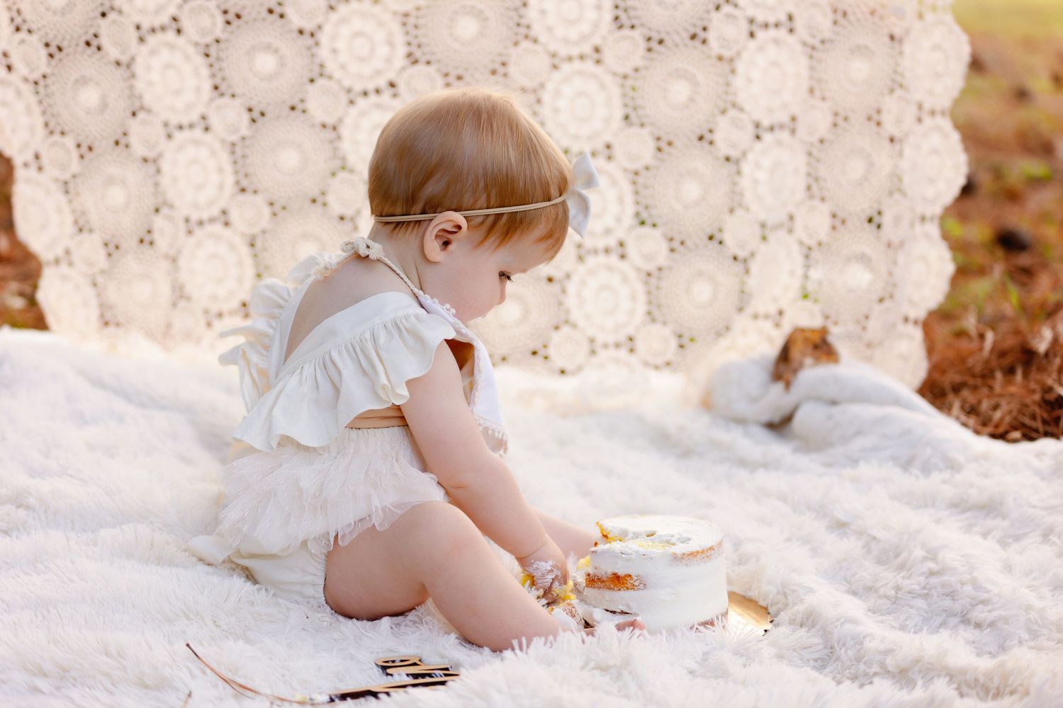 girl digging into cake. Greenville sc newborn photographer, Easley sc newborn photographer, Upstate sc newborn photographer