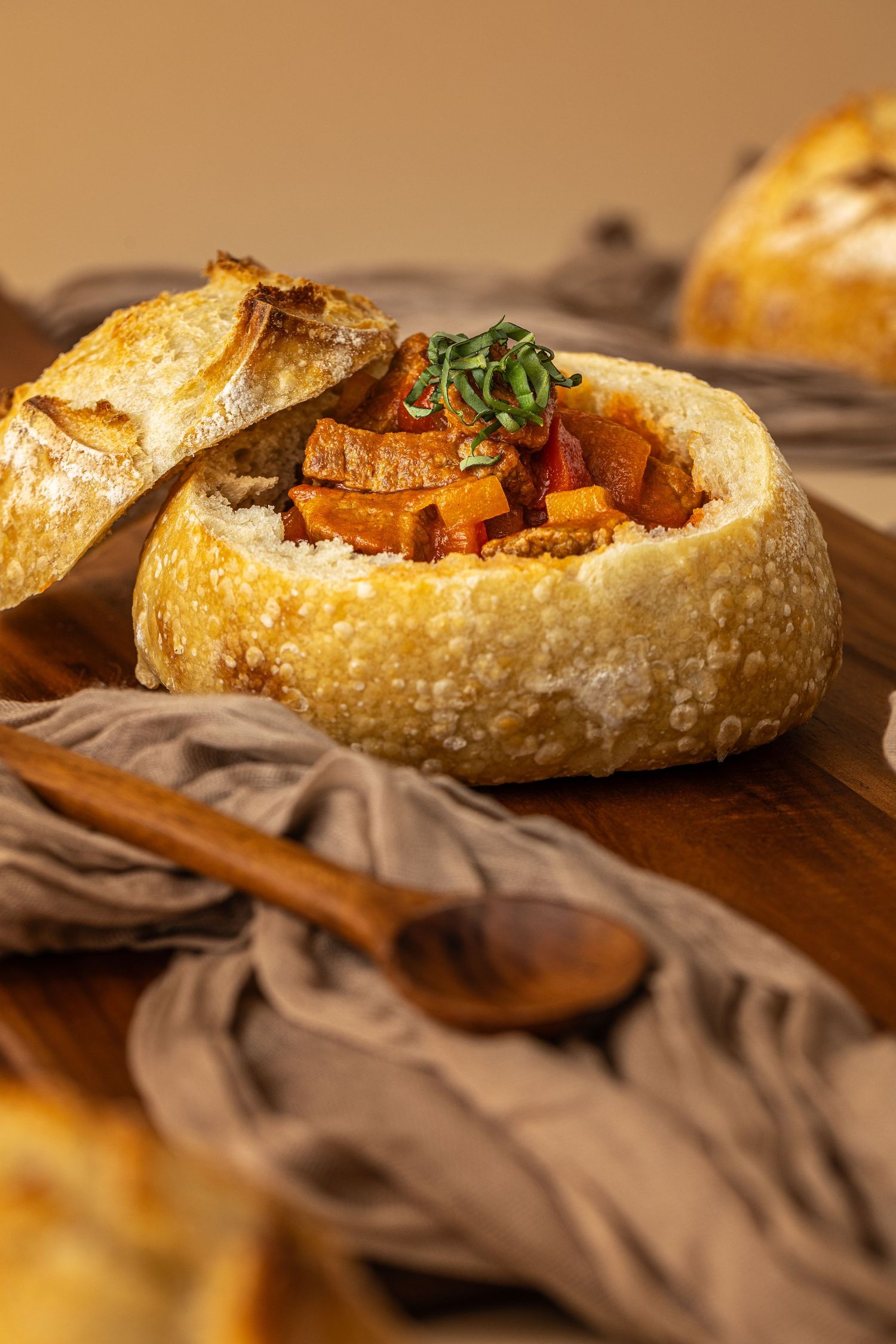 Hero shot of a scratch made sourdough bread bowl filled with beef stew made by Heartbakn catering in New Braunfels Texas