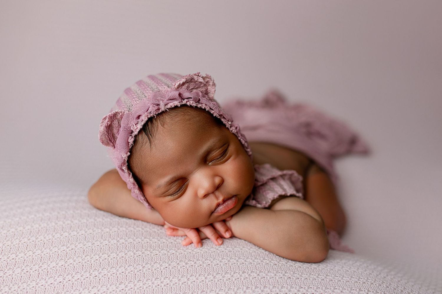 Baby girl with mauve hat sleeping on pink blanket in Flowertown Photography Studio in Summerville, SC