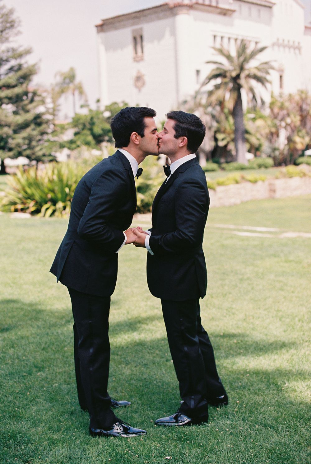 Two grooms kiss at their civil ceremony on the lawn of the Santa Barbara Courthouse.