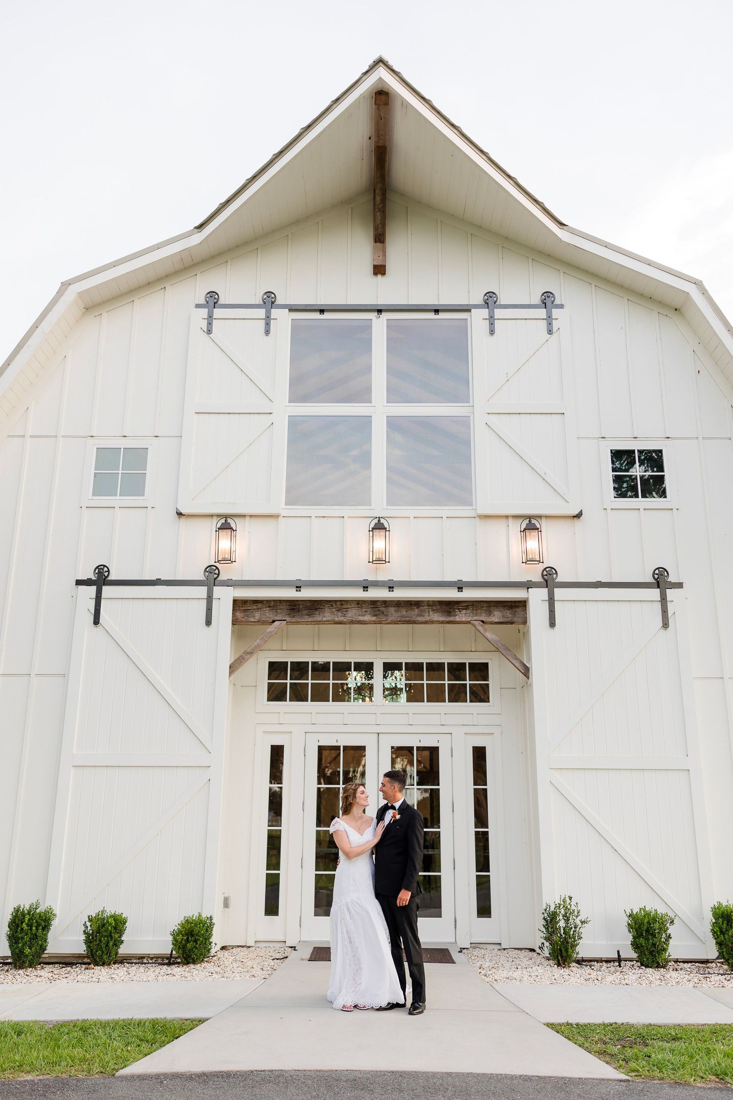 Wedding guests line up outside a church to throw confetti and celebrate the newlyweds during their exit.