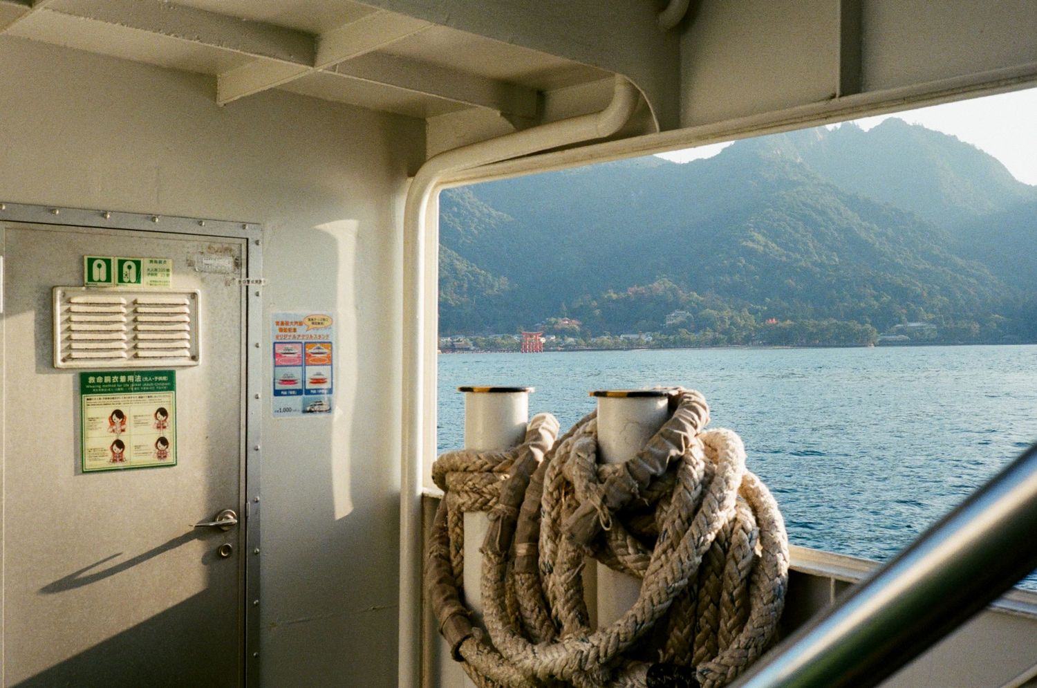 A collage of images showing a ferry ride across a scenic mountain lake with glimpses of interior cabin views.