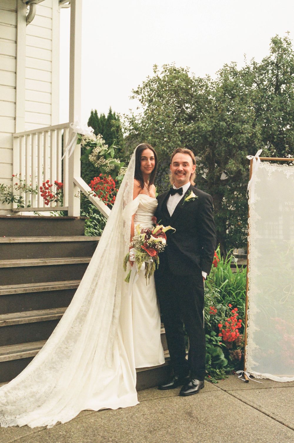 A wedding couple poses together in a series of candid shots on a porch with greenery and flowers in the background.