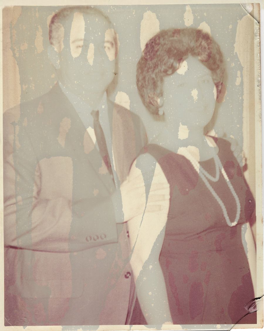 Vintage faded photograph from the 1960s showing two people in formal attire with a pearl necklace and suit.