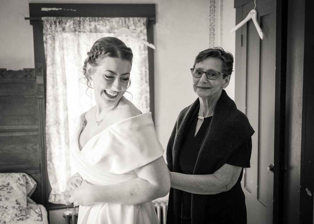 Black and white wedding portraits showing intimate moments in natural window light.