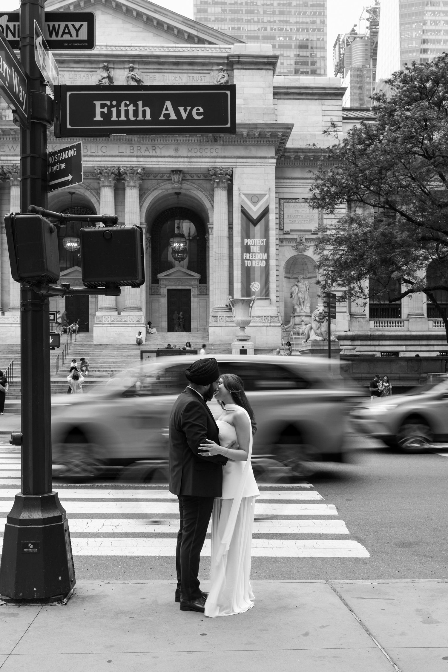 A bride and groom share a playful moment feeding each other wedding cake during their reception.