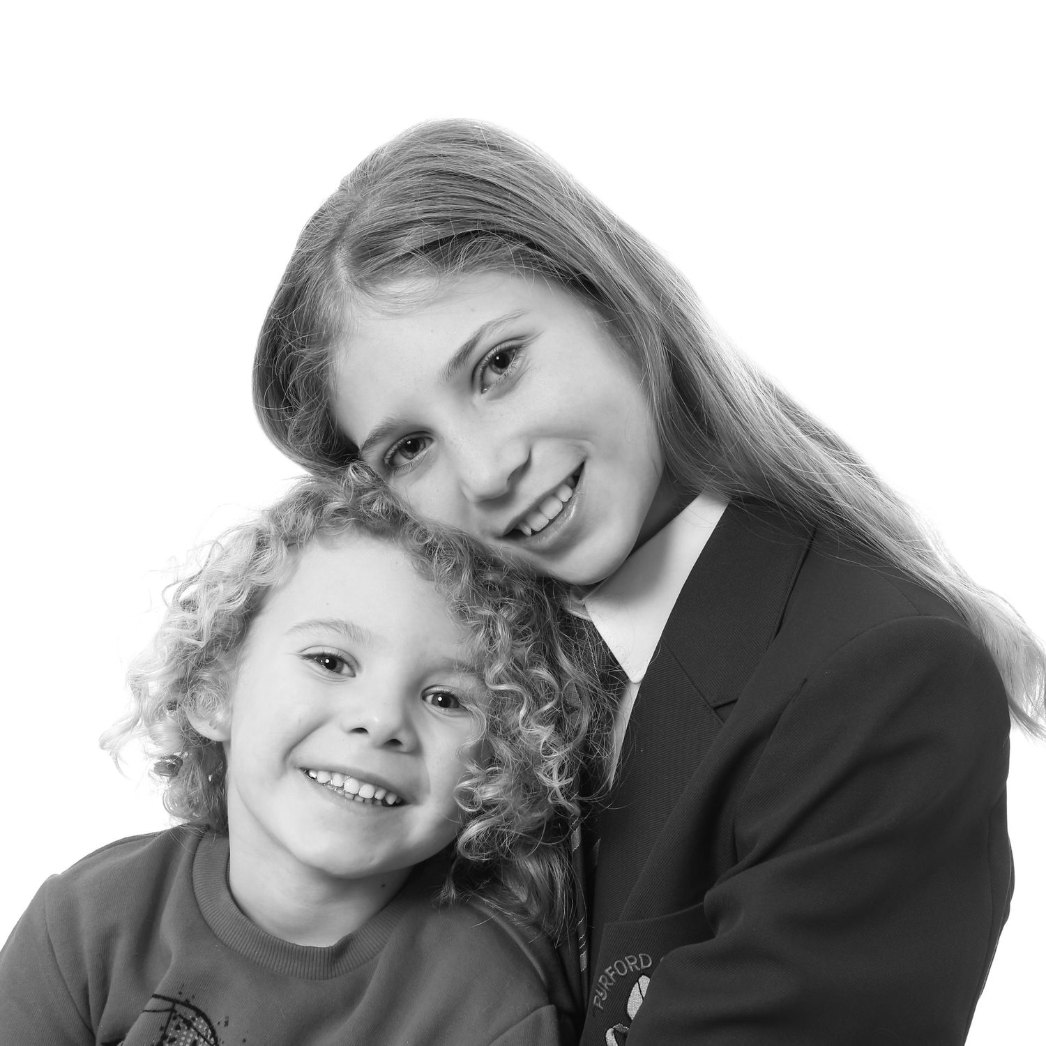 Photo of a 2 siblings showing an option in black and white. A school studio photo taken on a white background.