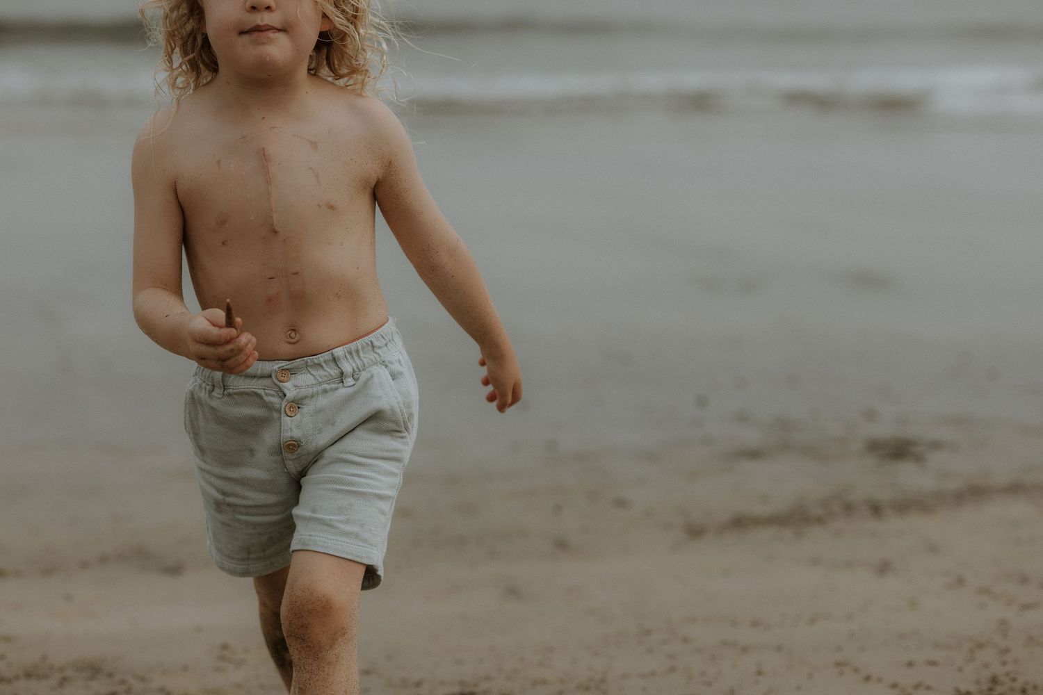 A candid beach photo showing movement and sandy textures.