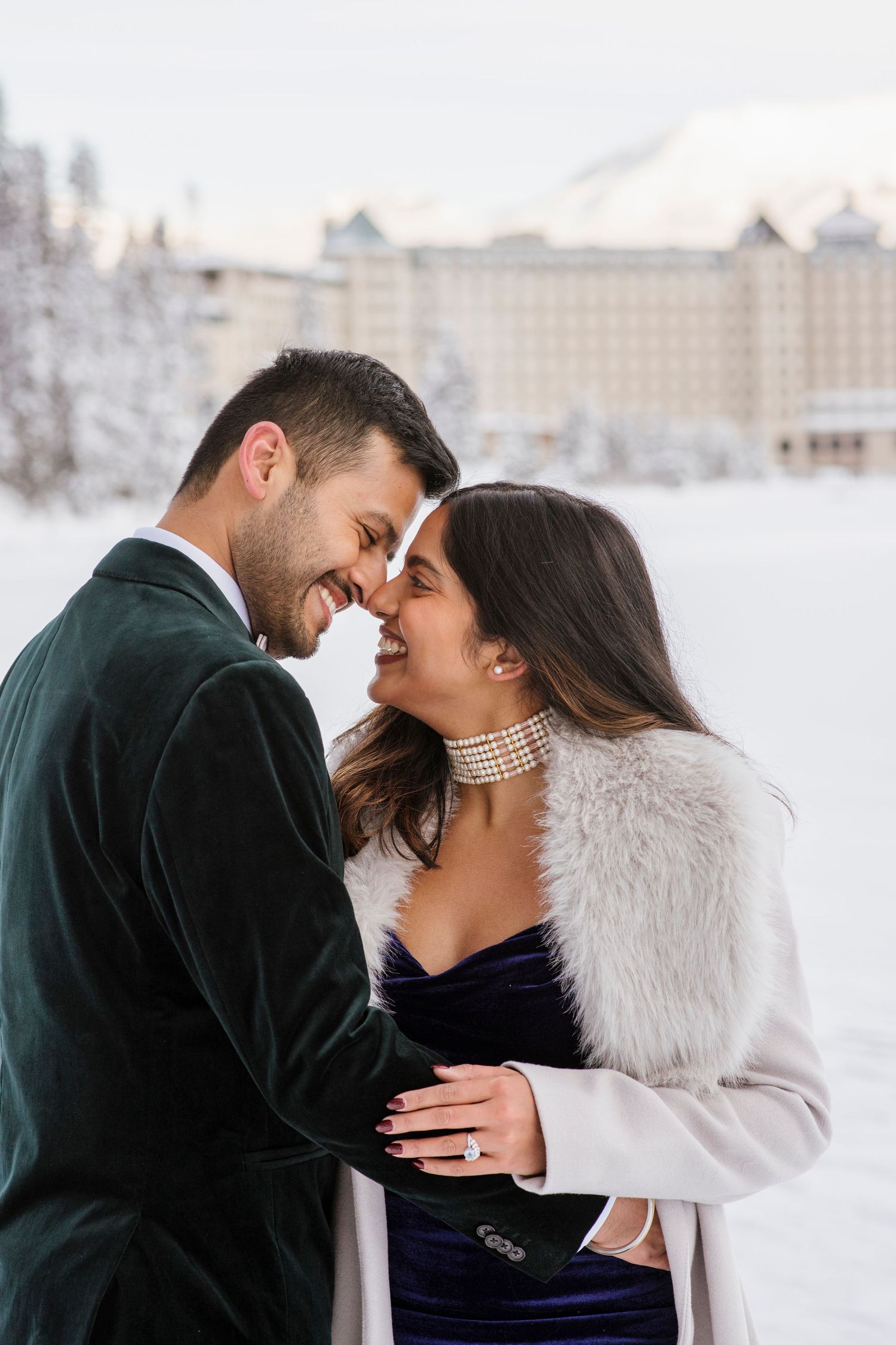 Frozen Lake Louise and Fairmont Chateau Lake Louise winter landscape with couple in foreground