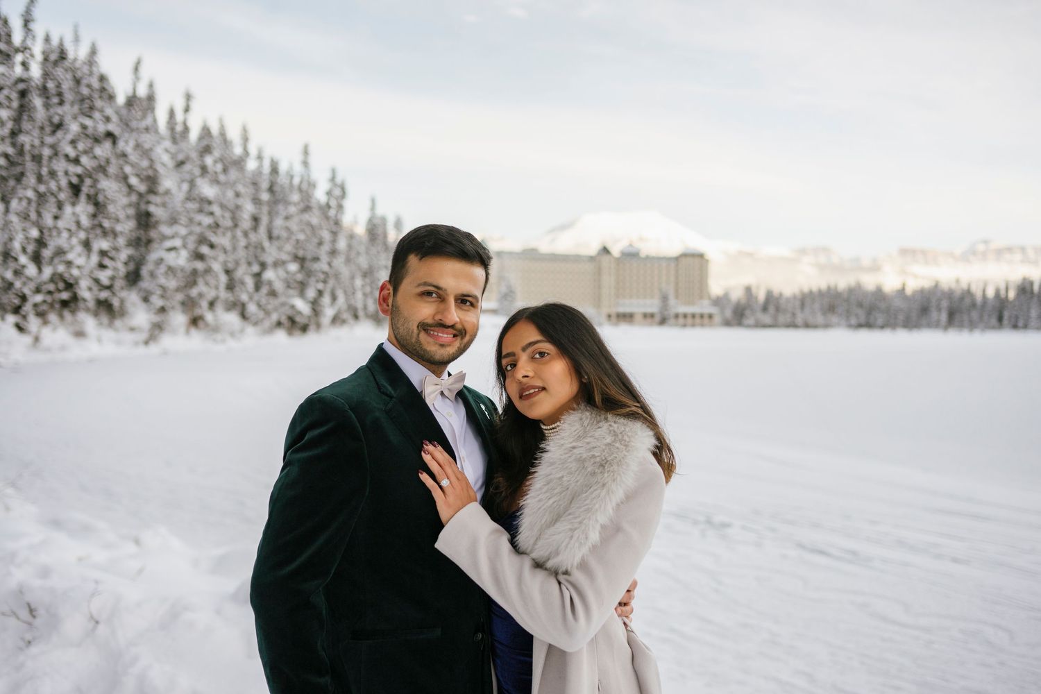 Frozen Lake Louise and Fairmont Chateau Lake Louise winter landscape with couple in foreground