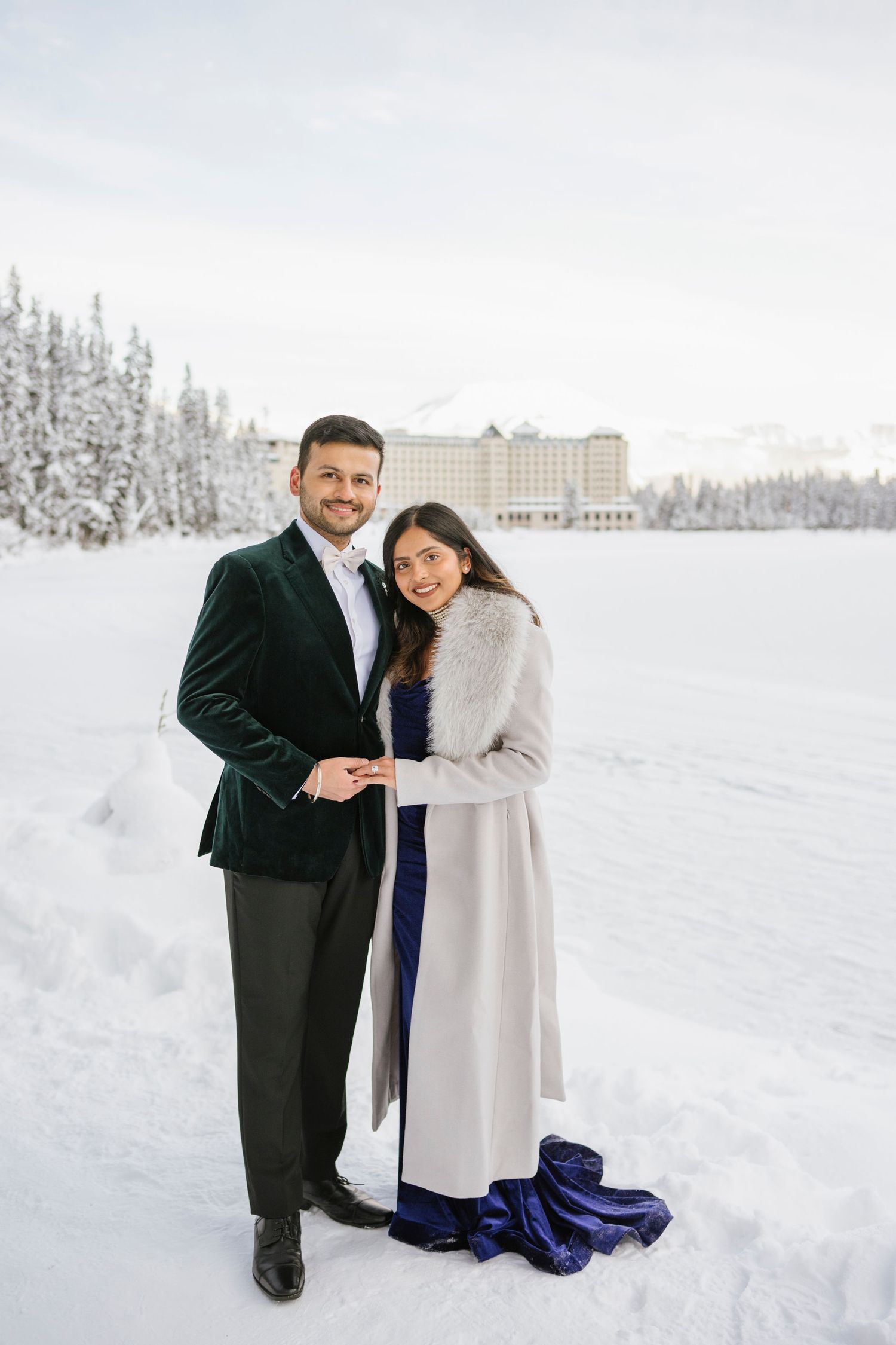 Frozen Lake Louise and Fairmont Chateau Lake Louise winter landscape with couple in foreground
