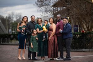 A large family standing together in a city area for the Christmas holiday