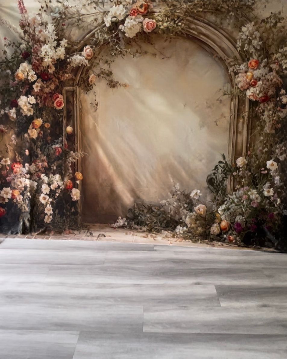 A amber hued floral arch backdrop.