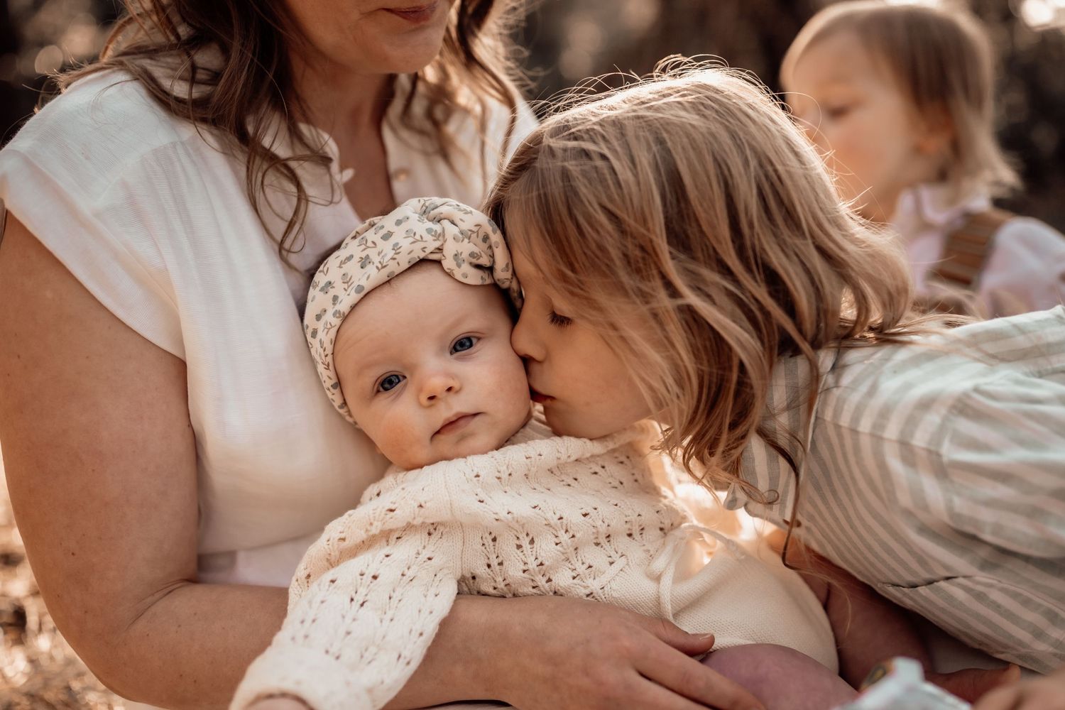 Heartfelt newborn & family photography capturing sibling love & tender moments. Warm, natural tones for timeless memories. Book today!