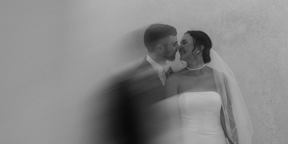 A dreamy black and white wedding portrait with soft focus and intimate pose.