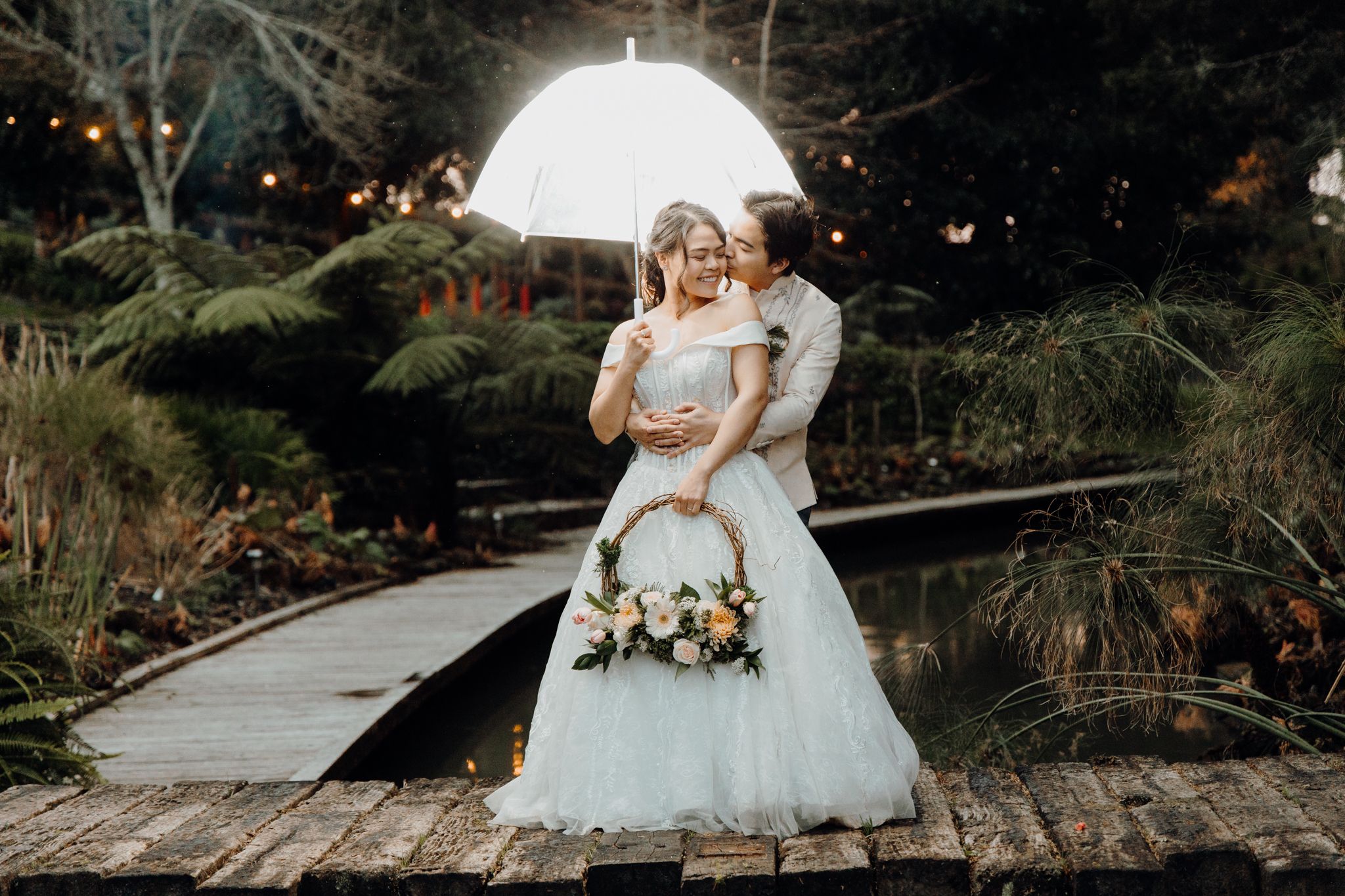 Newly wed couple enjoying their moment in Winsford Gardens. Captured by Apertured Media-Auckland Wedding Photographer