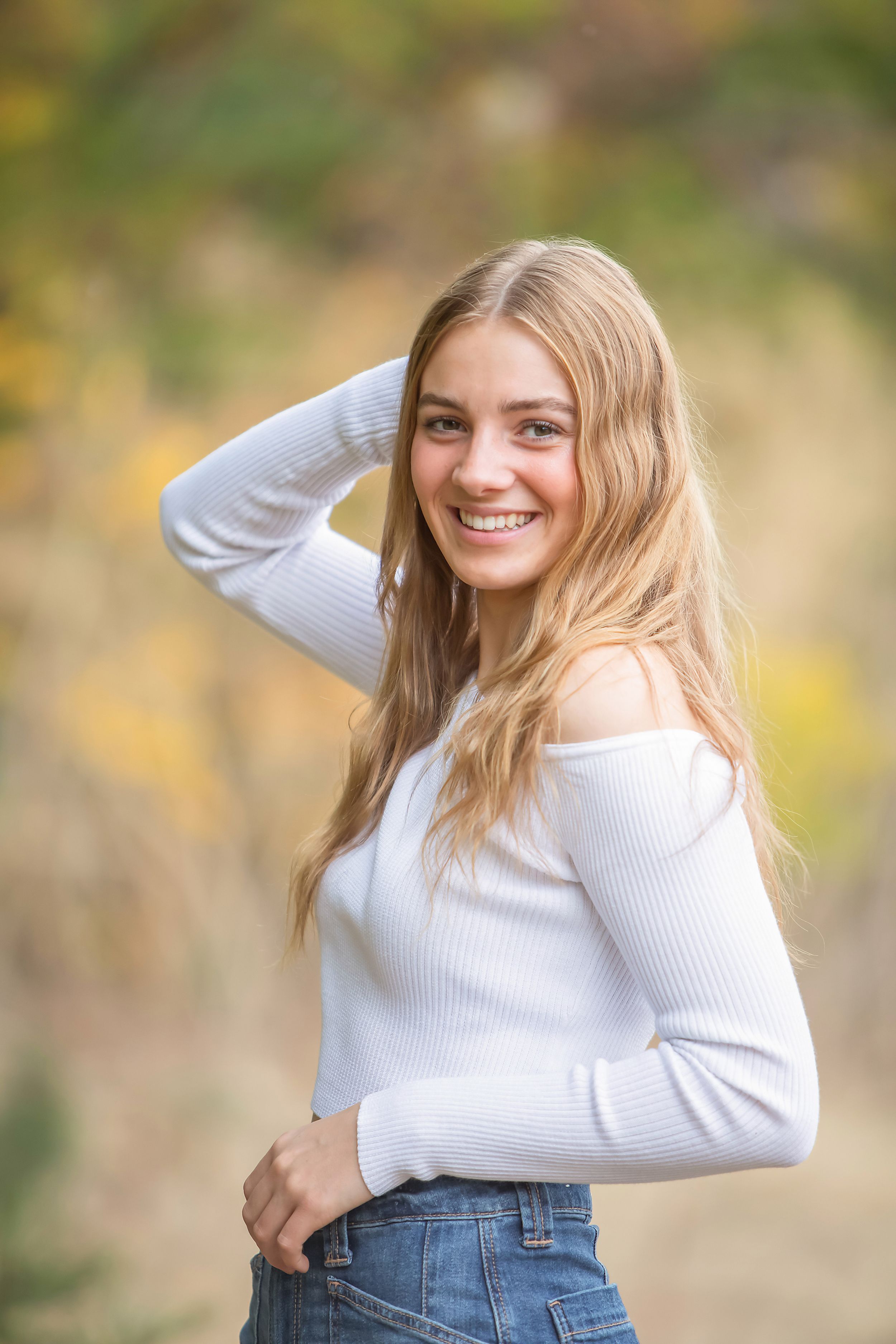 Series of casual portraits showing someone in a white sweater and jeans against a blurred autumn background.