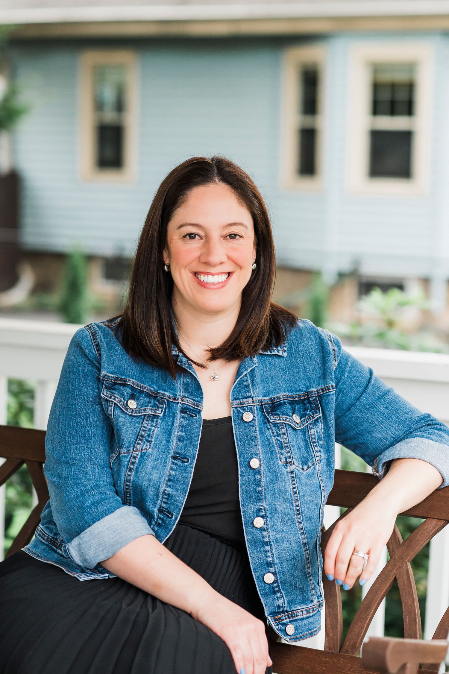A yoga or fitness class practicing stretching exercises together on orange mats in a studio space.
