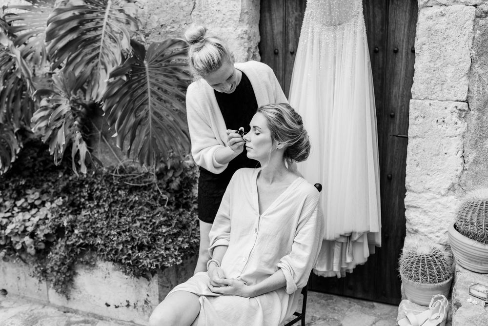 A romantic black and white wedding photoshoot featuring a couple dancing and embracing in an outdoor garden setting.