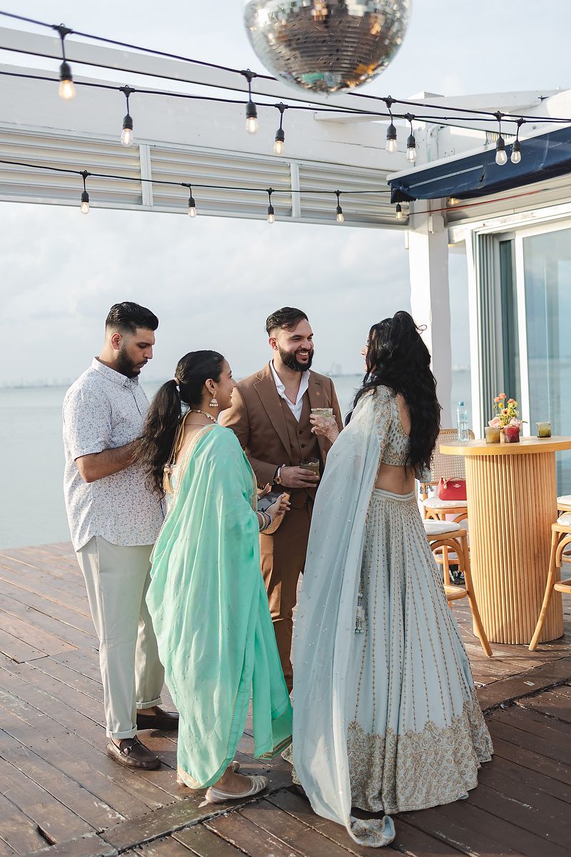 Couple and friends enjoying welcome party in Cancun Marina Riviera Maya photography.