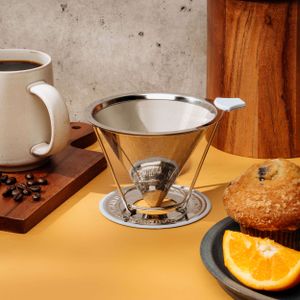 Coffee brewing setup with pour-over filter, coffee beans, and orange slice on yellow surface.