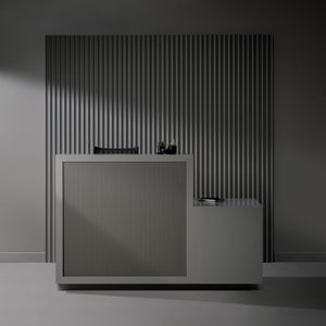 Minimalist grey reception desk with vertical striped wall backdrop.