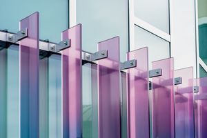 Row of pink and blue architectural columns creating geometric perspective pattern.